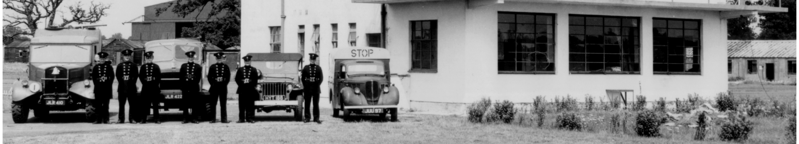 Landscape image in black and white Circa 1935. Membersof the military standing outside of Defford airfield office.