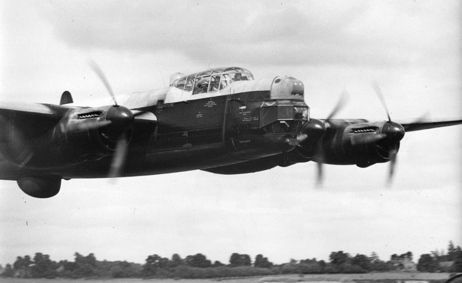 Lincoln aircraft flying in Defford airfields runways. A big plane with for propellers and large cockpit.